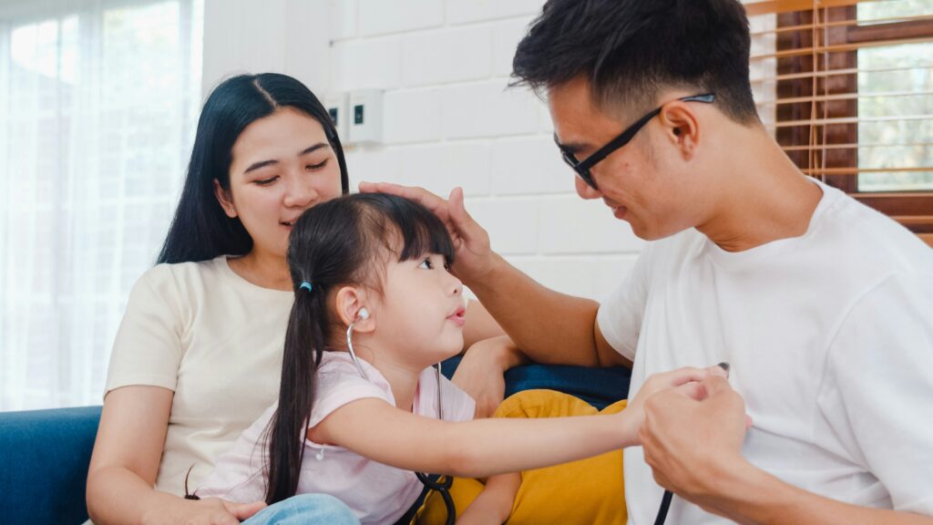 An image of a mother and father talking with their child after a couples therapy session in California.