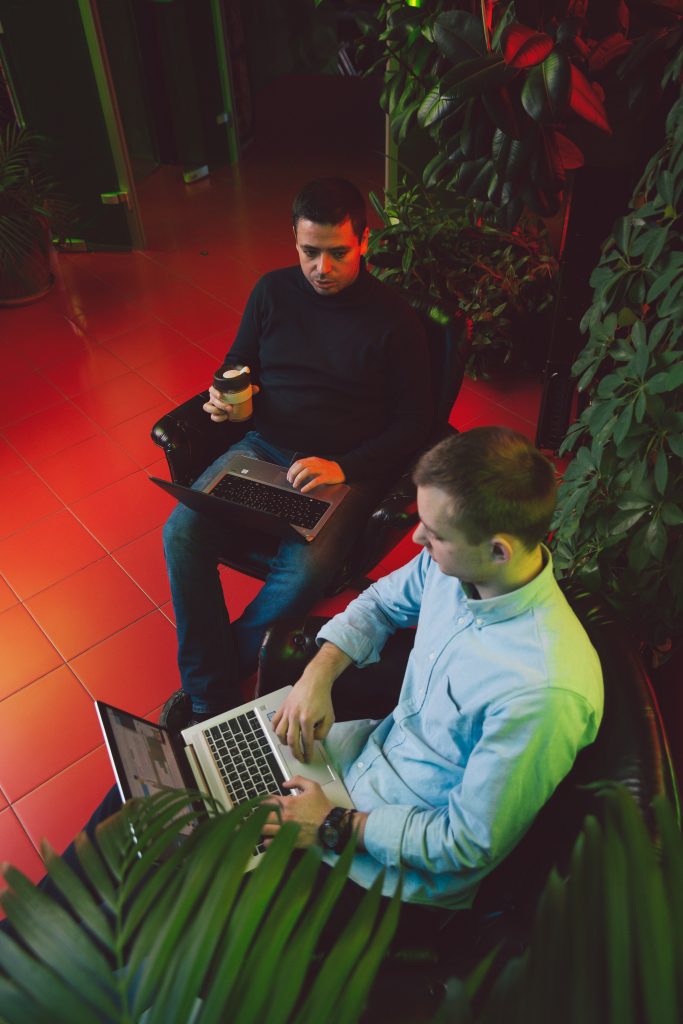 Image of 2 men working together on laptops. Showing that online therapy for men in Portland, OR can help from blurred boundaries when it comes to working from home. An online therapist in Oregon can help guide you.