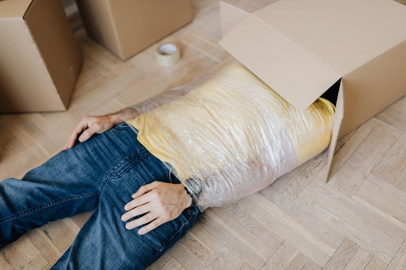 Image of a man wrapped in cellophane partially in a box. Are you searching for anxiety help due to anxiety symptoms in San Diego, CA? I am a San Diego anxiety therapist who can help you overcome these feelings. To get started reach out about starting anxiety treatment. Call today!
