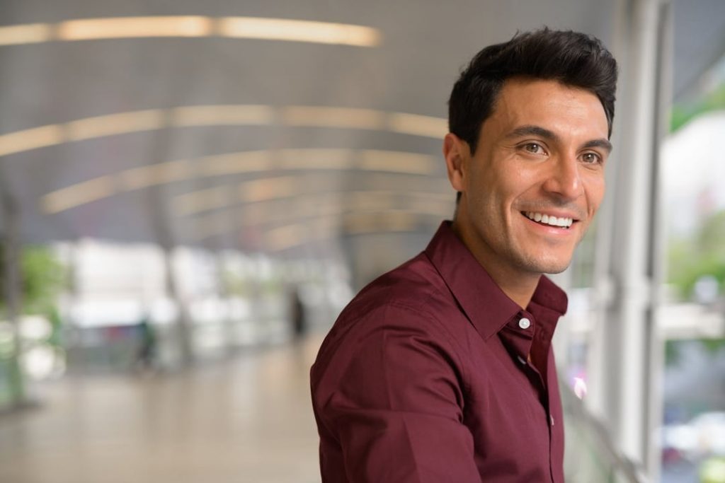 Image of a man in a maroon shirt smiling after finidhing individual therapy for adults in San Diego, CA. If you are feeling down there is hope for you too. Start smiling at life again with individual counseling in San Diego, CA.