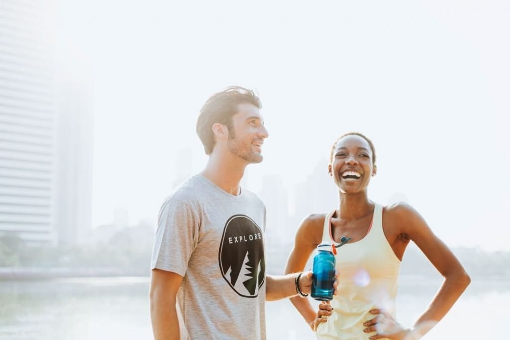 Image of a man and a woman taking a water break from running as a part of their addiction treatment in San Diego, CA. Addictions counseling combined with exercise is a great way to get and stay sober. A addictions counselor can help you make a routine, including running, to help you stay in recovery.