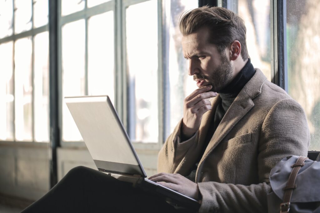 Image of a well dressed man typing on a laptop. Start working with a male therapist in California with therapy for men. Men's mental health is important! Start supporting your emotional health with a San Diego therapist for men. Call now!