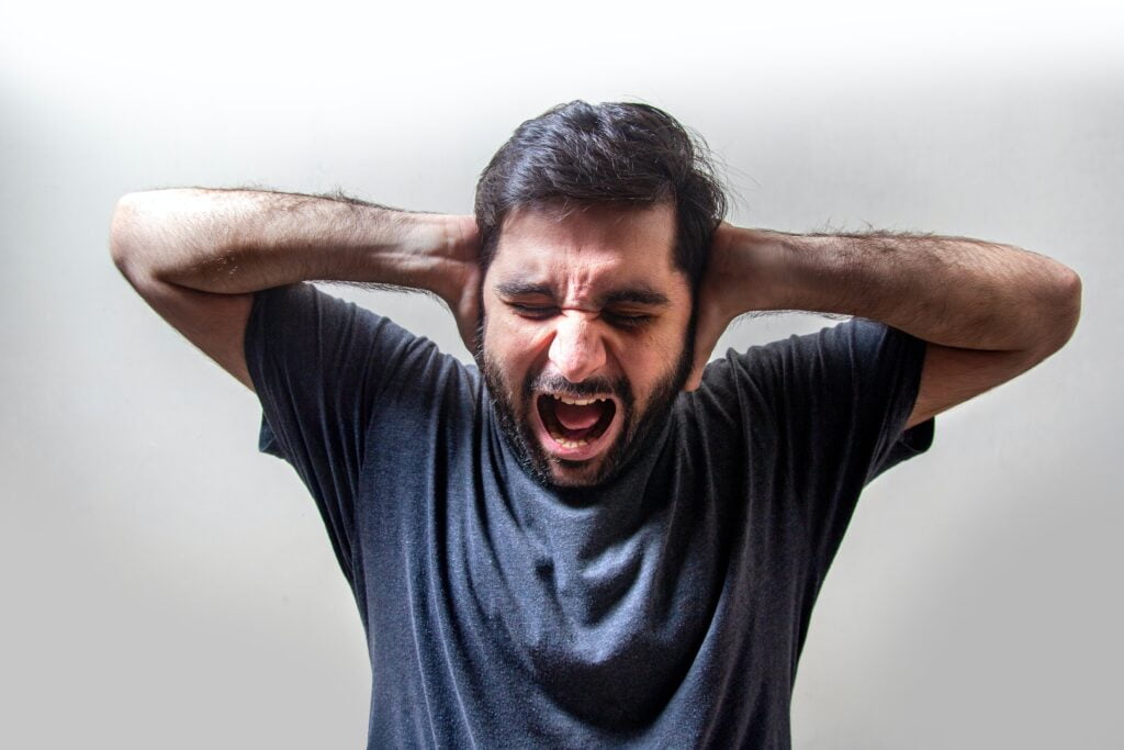 Image of a man screaming & covering his ears. Could you benefit from therapy for men? As a San Diego therapist for men I am dedicated to supporting men's mental health. Reach out today to talk to a male therapist in California.