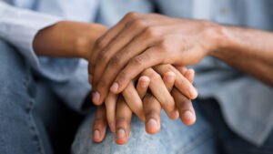 Image of a couple with their hands joined. Representing the bond that can grow stronger with support of a marriage counselor in San Diego, CA. you can combat the 5 biggest relationship enders in online marriage counseling.