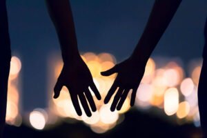 Image of to hands outstretched to each other. Representing the healing that happens when working with a San Diego couples therapist. In infidelity counseling, or infidelity therapy, can help bridge the space after an affair.