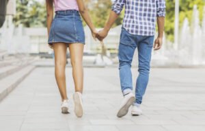 Image of a couple holding hands walking away from the camera. Representing the relationship that can be had after infidelity therapy, or online couples counseling, in Portland, OR. Where you can gain skills to rebuild your relationship from an online therapist in Portland, OR.