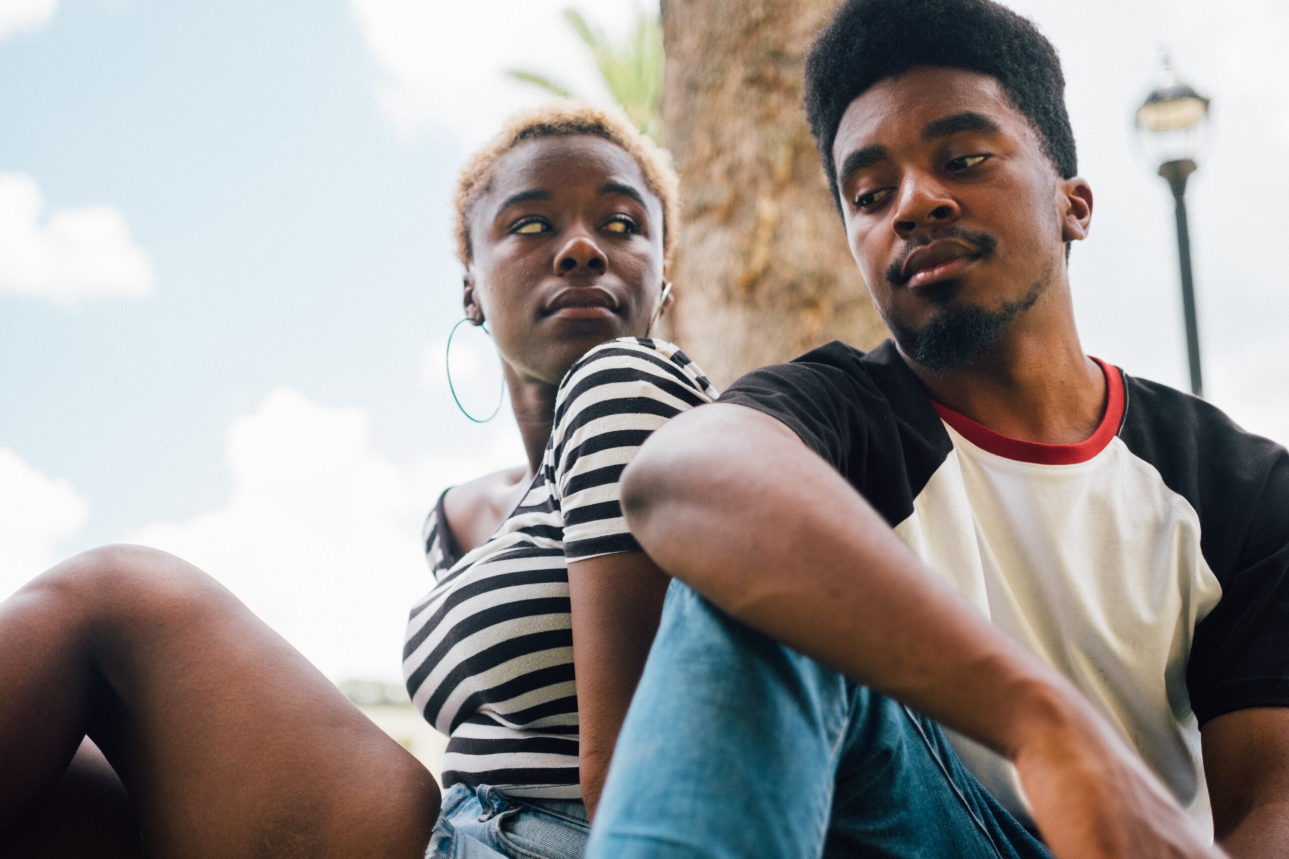 image of a young couple giving each other the side-eye, and wondering how to get the most out of couples therapy in California, Oregon and Florida
