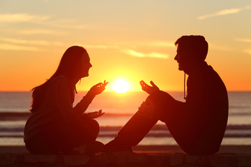 Silhouettes of a couple sitting in front of a sunset at the beach and having playful conversation. Learn more about couples therapy in San Diego and the support online couples therapy in California can offer. Search for a San Diego couples therapist to learn more today. 