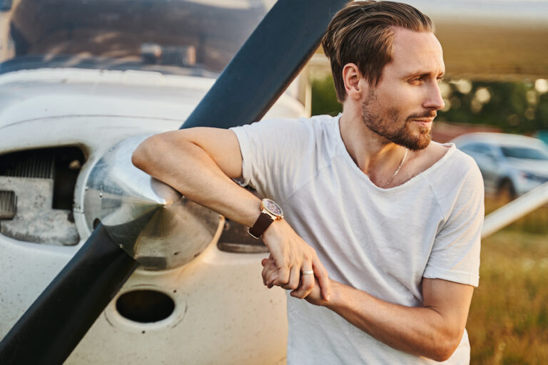 Photo of man near plane, representing overcoming fears (including fear of flying) after benefiting from therapy for anxiety in San Diego.