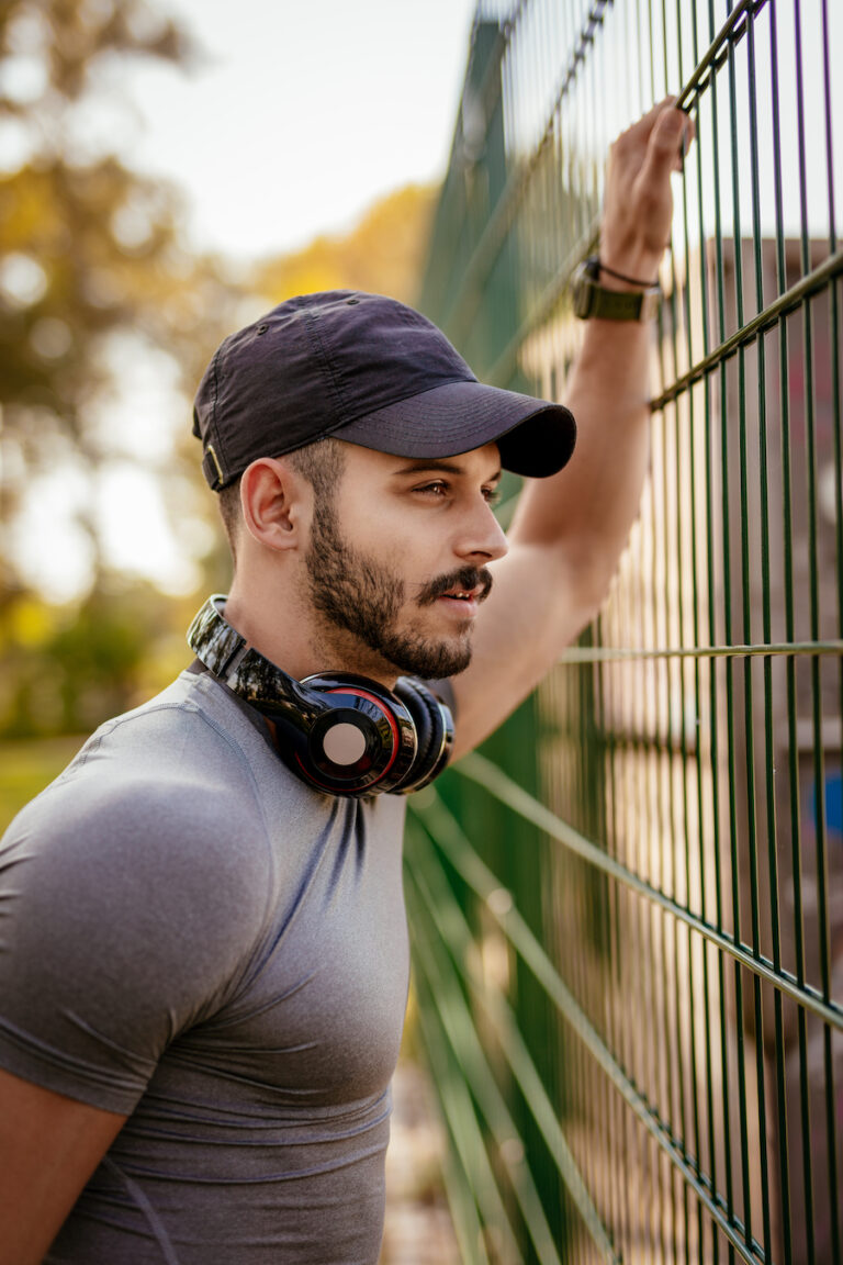 Young man after workout in the park looking to increase confidence through online therapy.