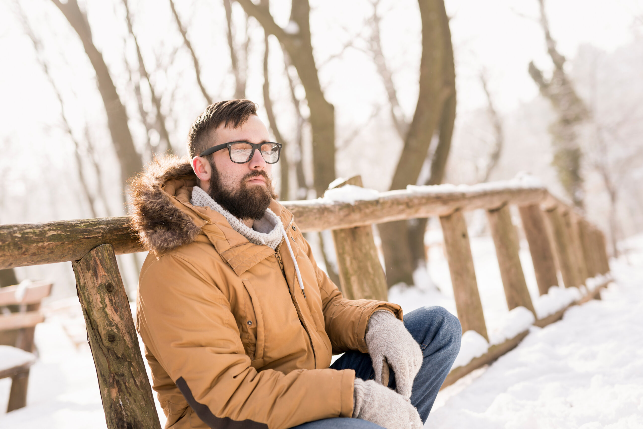 A man smiles while sitting on a bench in the winter. Learn how an online therapist in Oregon can offer support with anxiety help in San Diego and across the country. Learn more about the help a San Diego anxiety therapist can offer by searching for Stress management in San Diego, CA