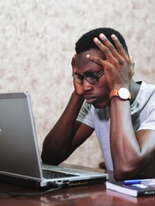 A man with a frustrated look holds each side of his head while looking at his laptop. Learn tips for stress managment in San Diego, CA by contacting a San Diego anxiety therapist. Search for anixety help via an online therapist in California.
