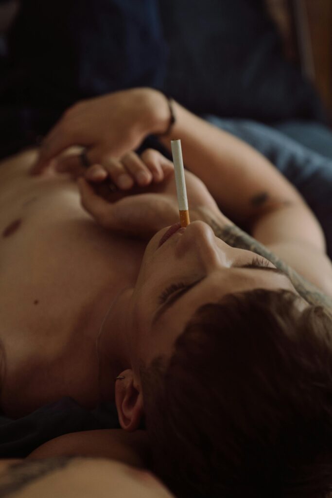 An image of a man smoking a cigarette in need of support for addiction from his partner