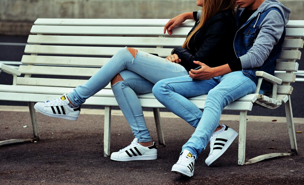 A couple sitting on a bench, holding each other and reflecting the blog’s focus on identifying common obstacles to turning toward your partner and exploring ways to address these challenges in relationships in California.