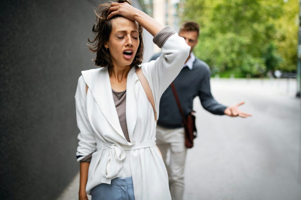 A frustrated woman walking away from her partner, showcasing the tension and emotional toll caused by retaliation or revenge in relationships.