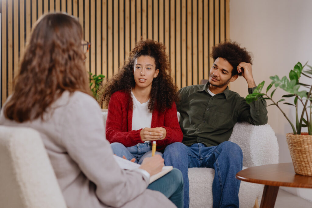 Couple meeting with a therapist during Gottman Couples Therapy to improve communication and learn how to reconnect with your partner.