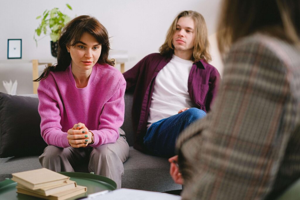 Couple sitting in couples therapy looking tense, representing communication challenges explored in San Diego couples therapy.
