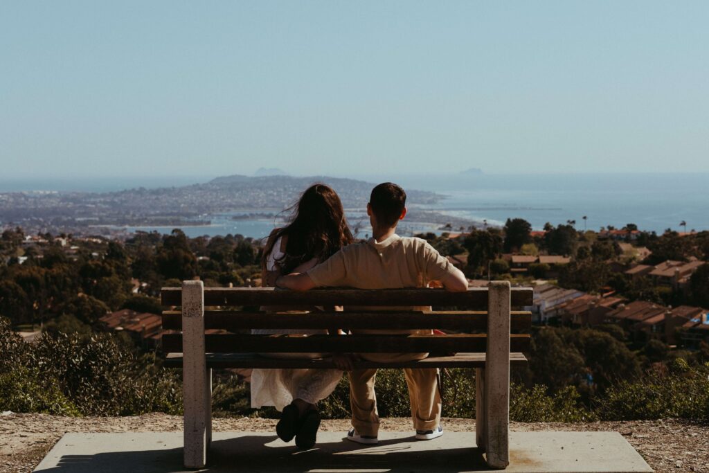 Couple sitting together on a bench in San Diego, representing reflection, connection, and personal growth supported through relationship counseling in San Diego, CA.