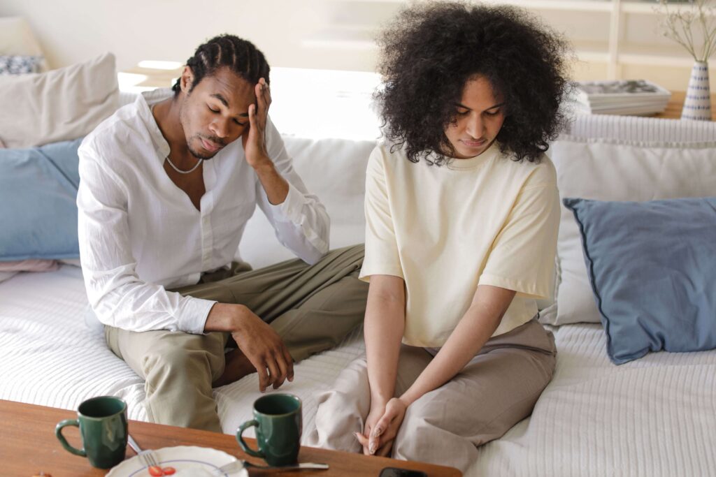 Couple appearing stressed and emotionally distant, illustrating relationship struggles addressed in relationship counseling in San Diego, CA.