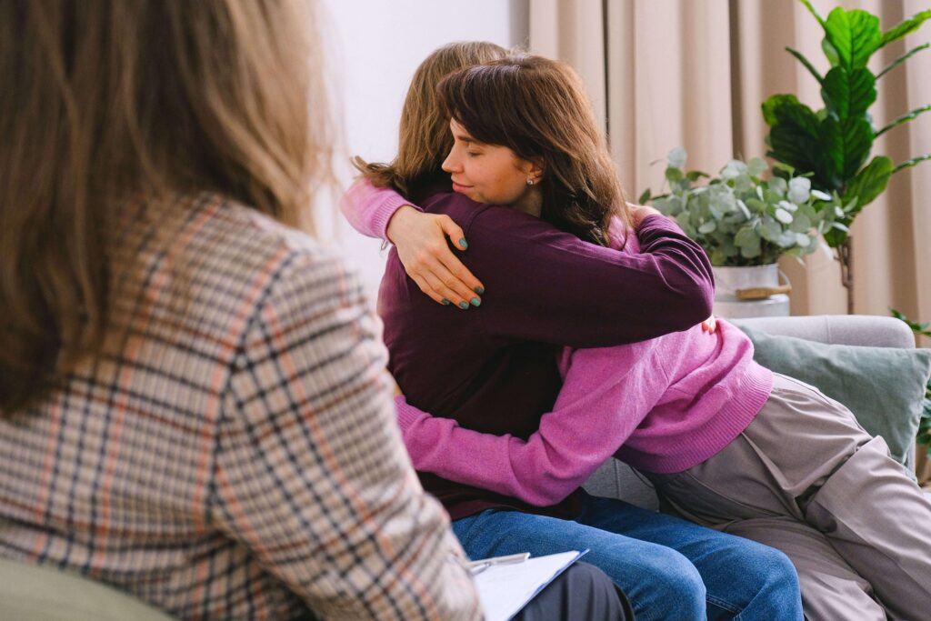 Couple hugging during a counseling session, symbolizing healing, trust, and renewed closeness through couples counseling in San Diego, CA.