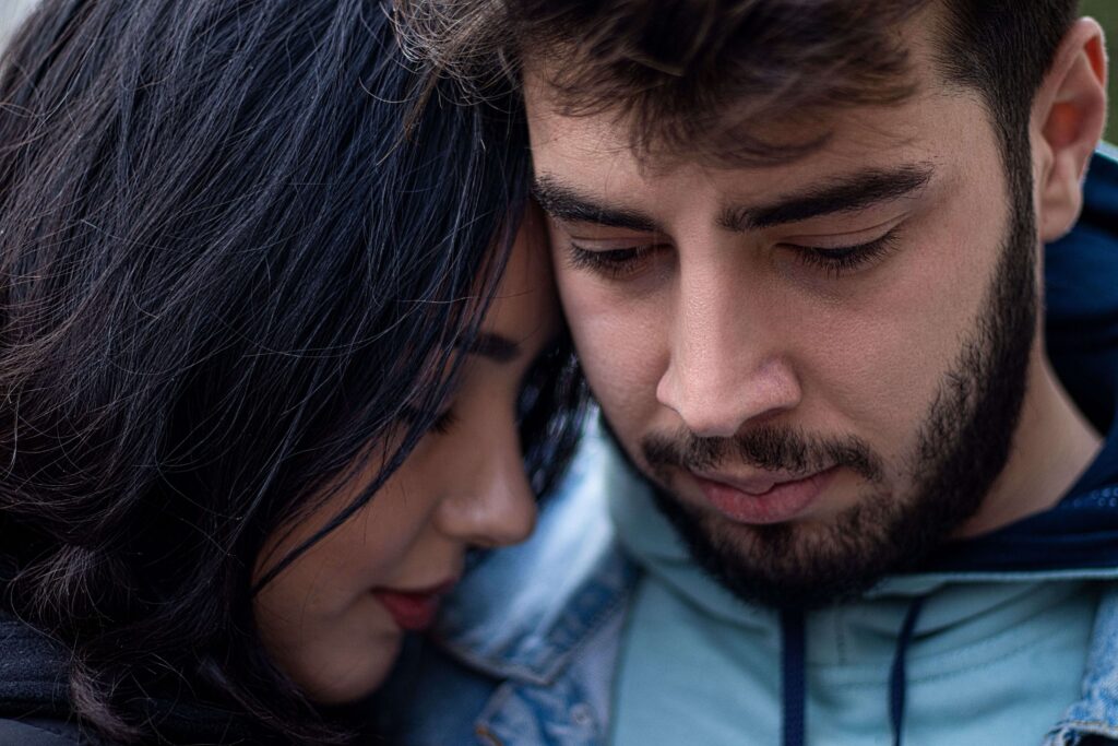 Close-up of a couple resting their heads together, symbolizing trust, security, and emotional closeness supported through couples therapy in San Diego, CA.