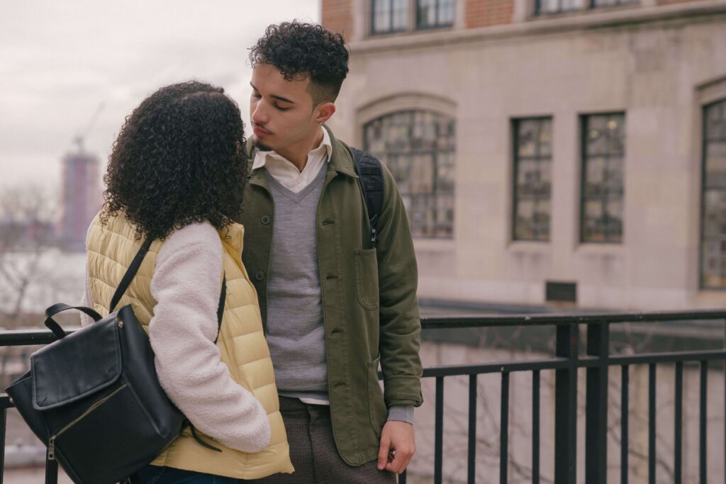 Couple looking at each other, illustrating emotional awareness and connection explored through couples therapy for attachment styles in San Diego, CA.