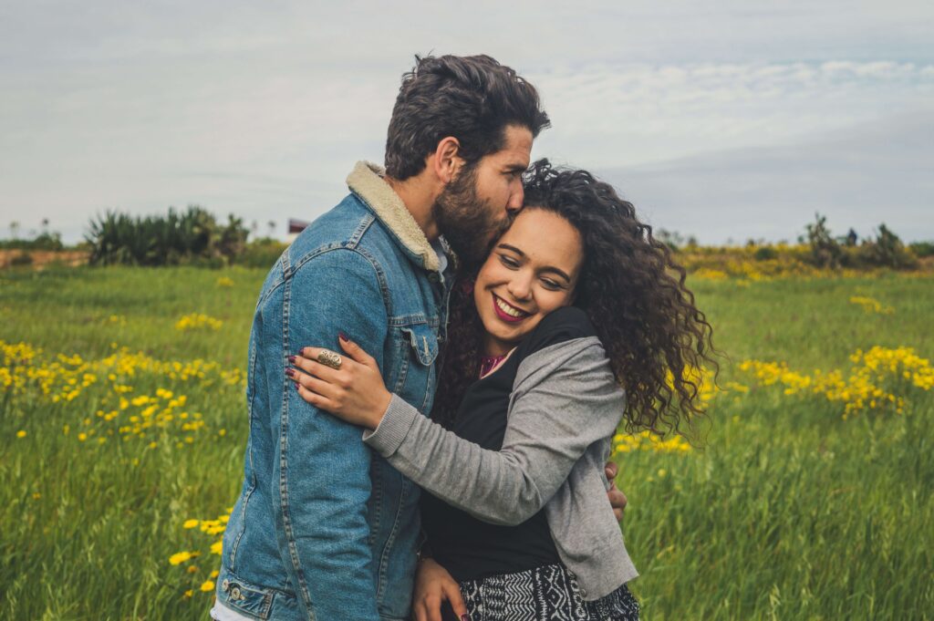 Happy couple smiling together, symbolizing greater emotional intimacy, closeness, and a stronger relationship bond supported through couples counseling in San Diego, CA.