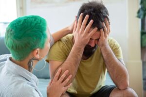 Couple appearing distressed during a difficult interaction, representing recurring relationship conflict and trigger responses addressed through couples therapy in San Diego, CA.