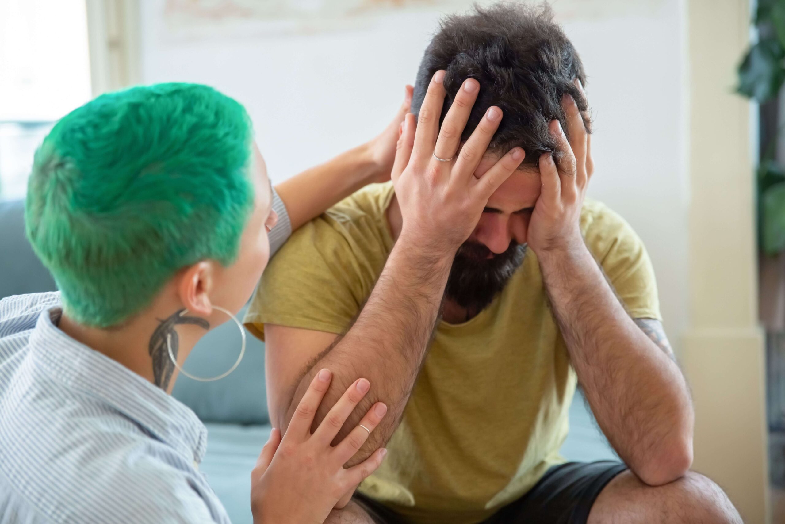 Couple appearing distressed during a difficult interaction, representing recurring relationship conflict and trigger responses addressed through couples therapy in San Diego, CA.
