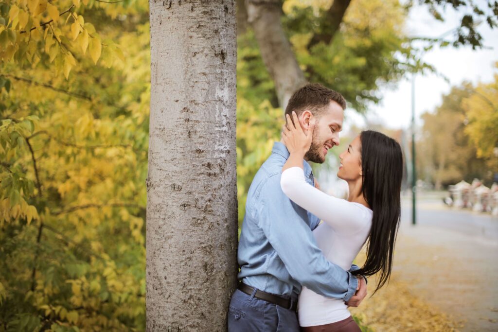 Happy couple smiling together, symbolizing improved communication, emotional connection, and healthier relationship patterns supported through couples therapy in San Diego, CA.