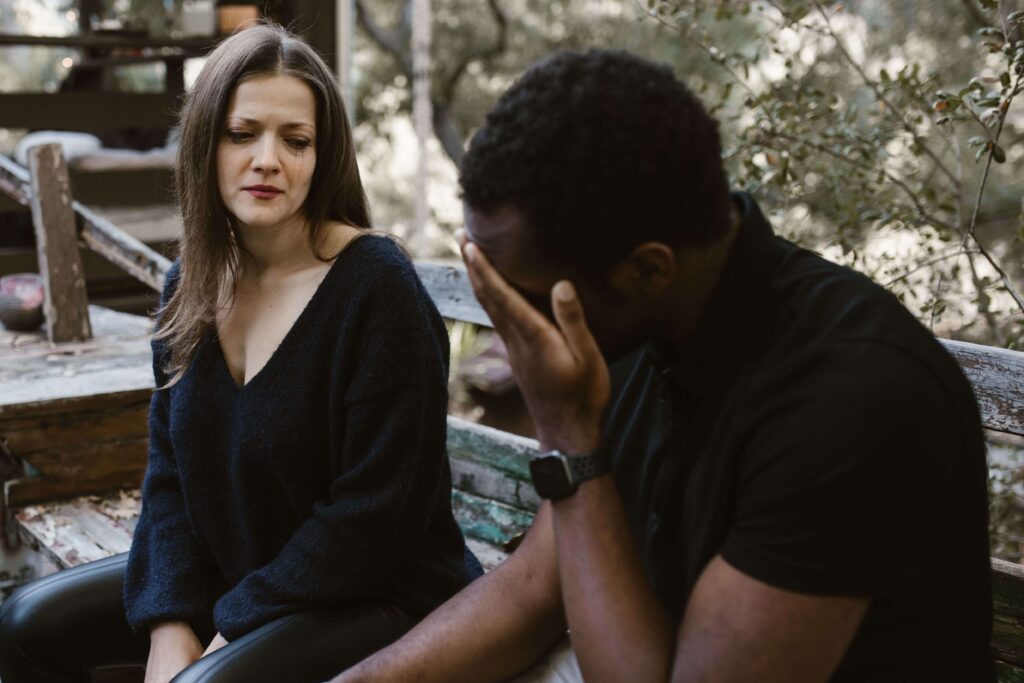 Stressed couple navigating relationship difficulties, illustrating emotional tension and conflict patterns explored through couples therapy in San Diego, CA.