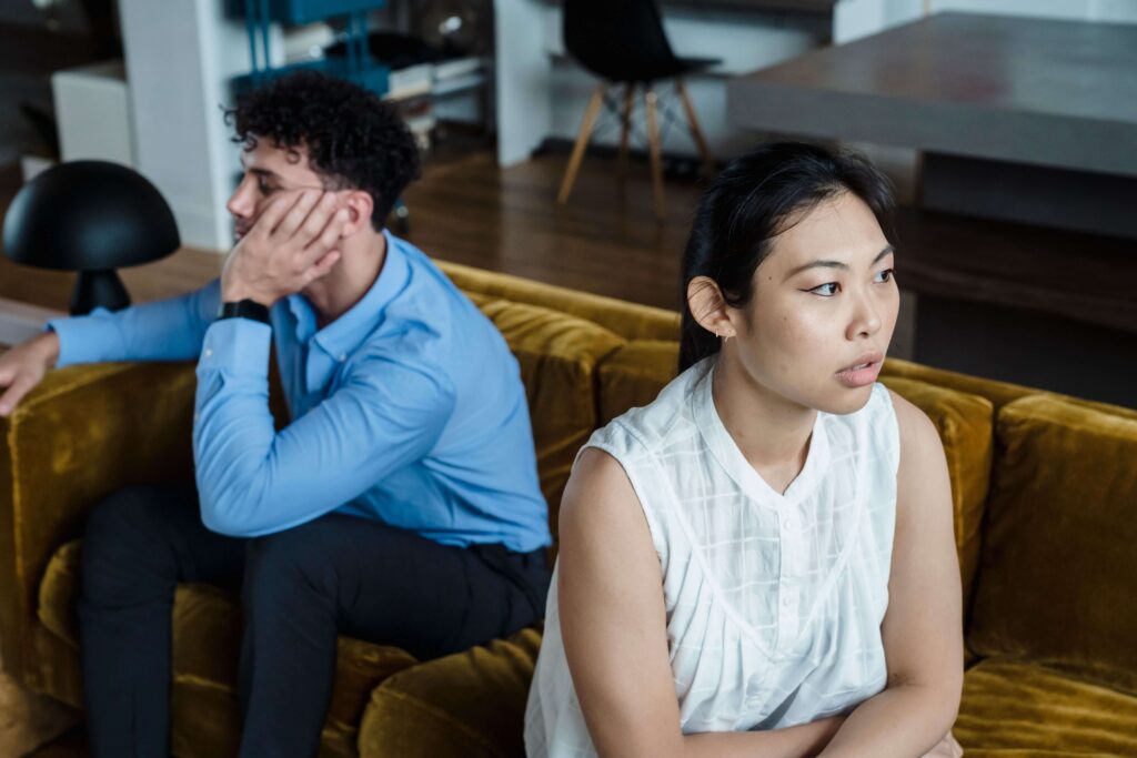 Couple appearing distressed during a difficult interaction, representing communication struggles and emotional disconnection addressed through couples counseling in San Diego, CA.