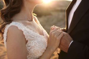 Close-up of couple getting married, representing the commitment and new beginnings that may lead couples to seek marriage counseling in San Diego, CA.
